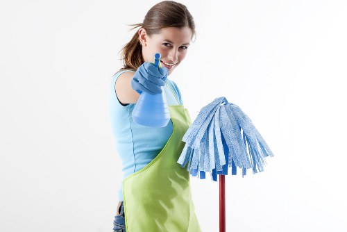 Carpet cleaning technician using professional equipment in a safe home environment