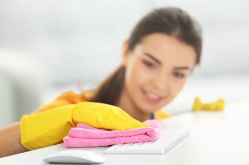 Cleaner wearing PPE while performing a carpet cleaning task