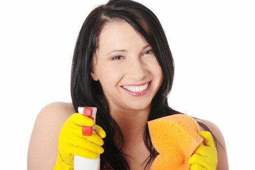 Office cleaners sanitising shared workspace in E1